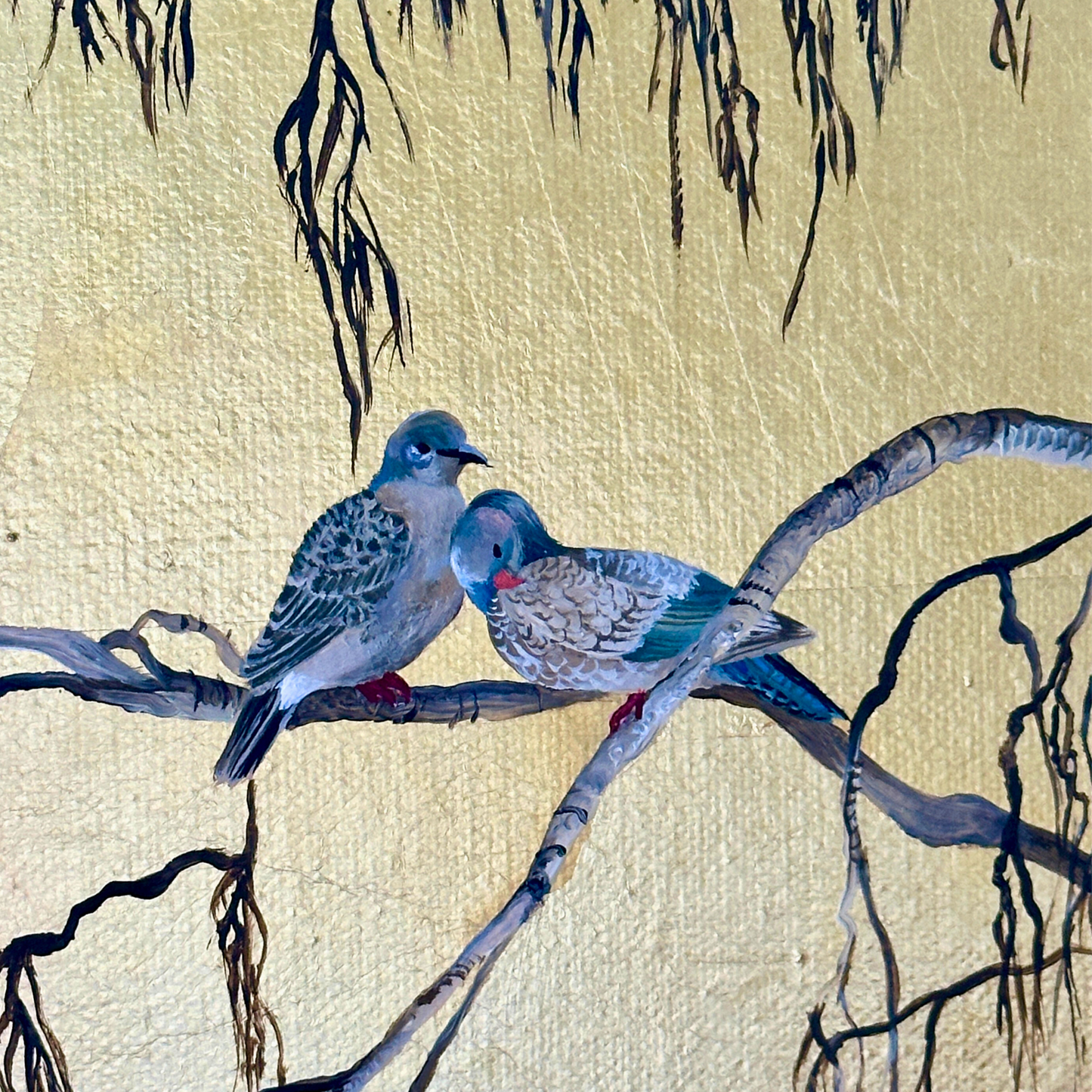 painting of two stock doves resting on a silver birch branch. painted in acrylics with a gold leaf background