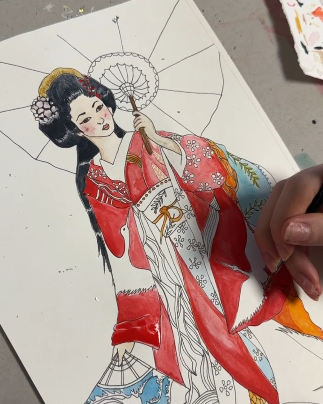 hand painting the Umi Design in watercolours